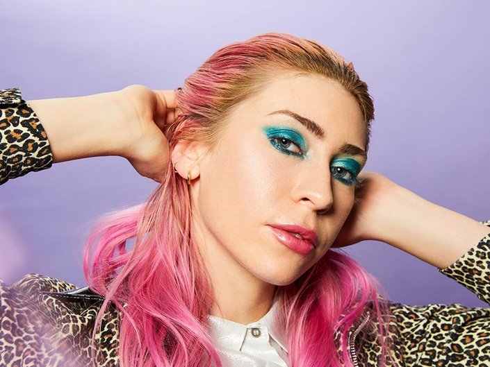 person wearing jewel-toned eye makeup
