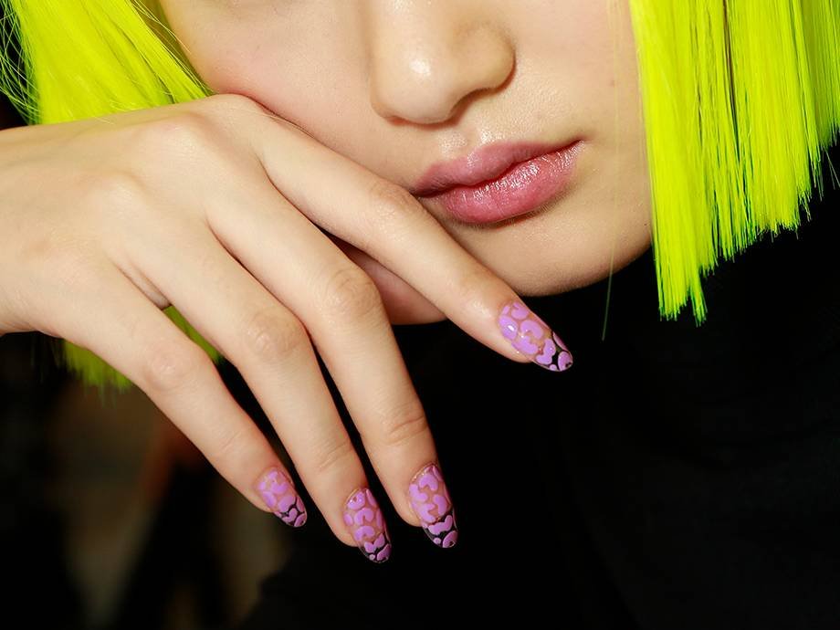 person wearing lime green bob and nail art on nails