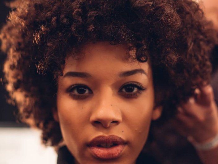 person with naturally curly hair in afro