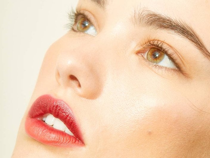 person wearing natural makeup and red lipstick