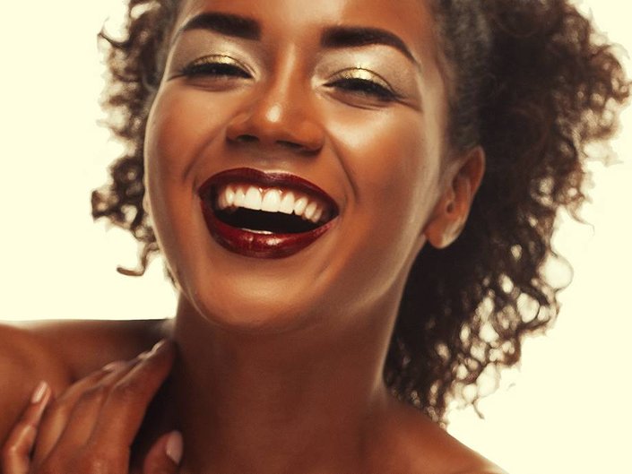 person with dark skin wearing brown lipstick