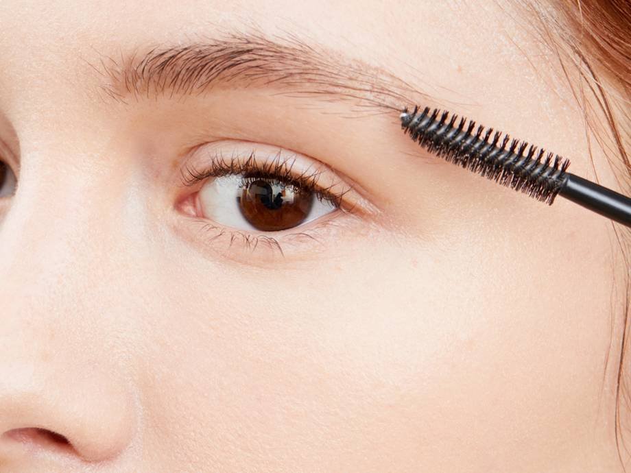 person applying eyebrow gel