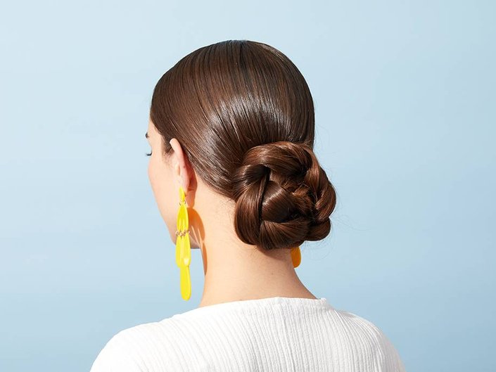 person wearing low braided bun