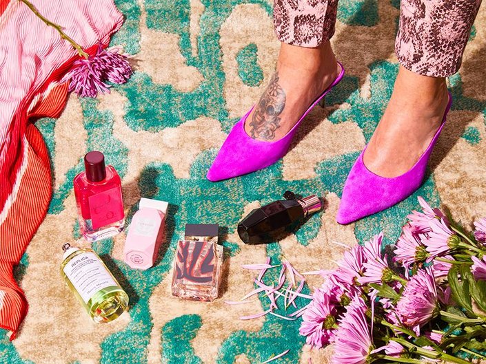 various fragrances on rug in front of someone's feet
