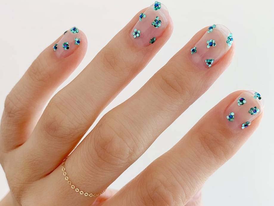 hand with colorful rhinestones on nails
