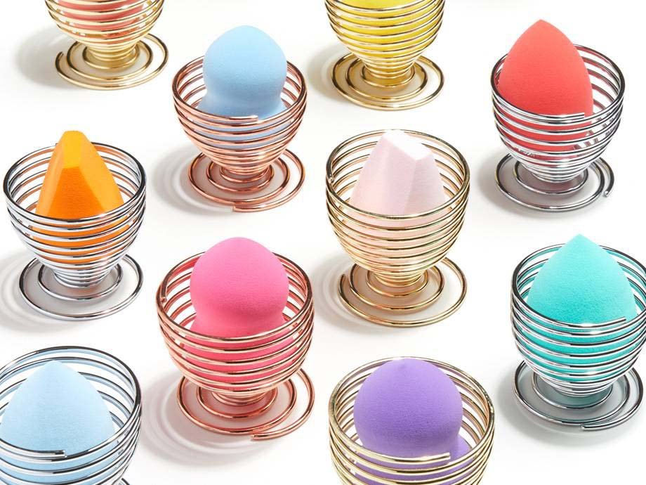 colorful makeup sponges in various egg holders