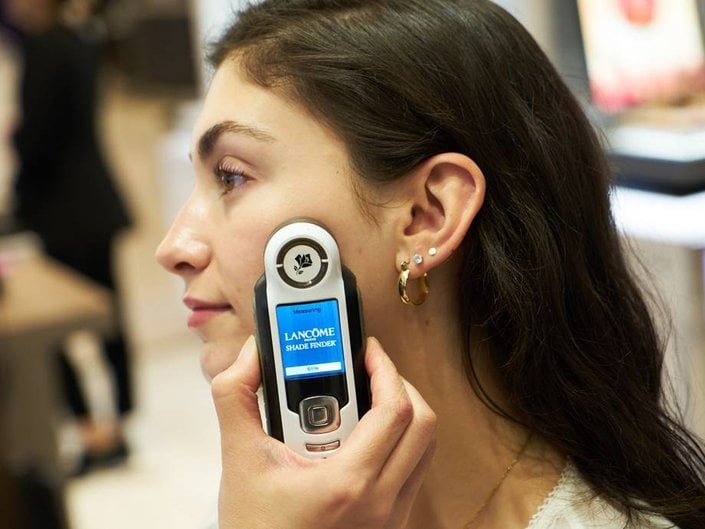 person using lancome e-shade finder
