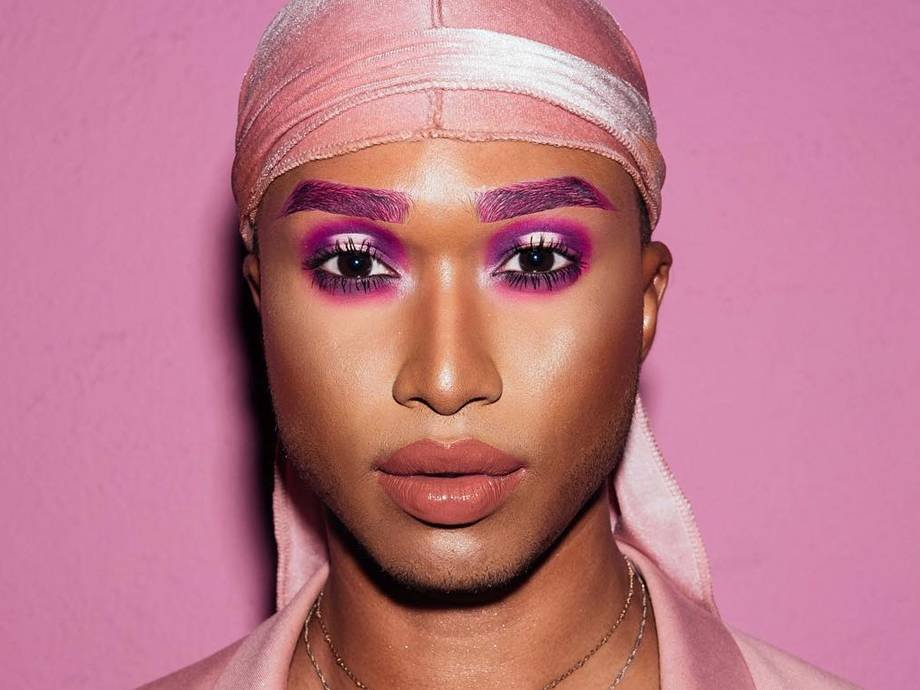 person wearing a pink durag and fuchsia eyebrow and eye makeup