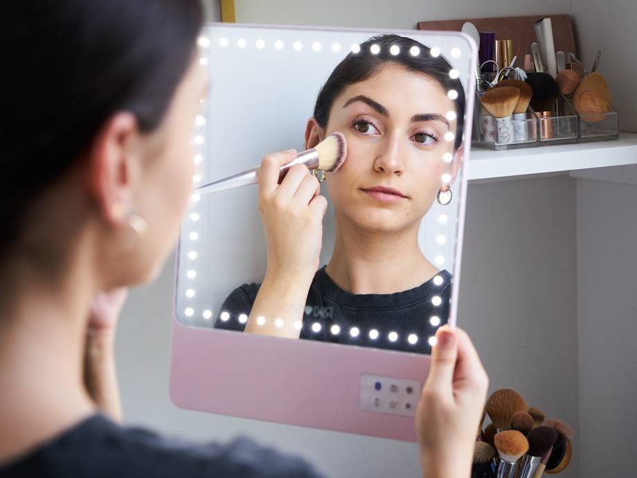 person applying makeup in glamcor riki skinny mirror