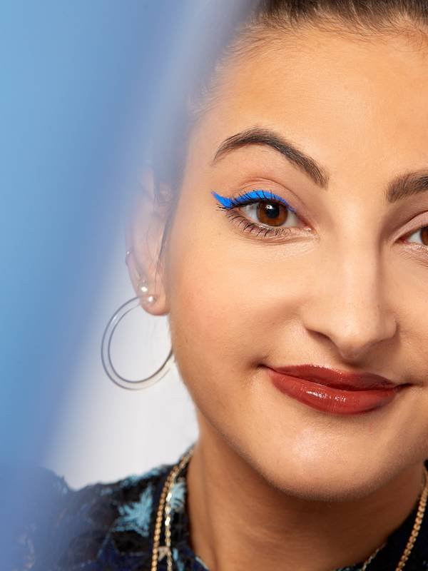person wearing blue eyeliner