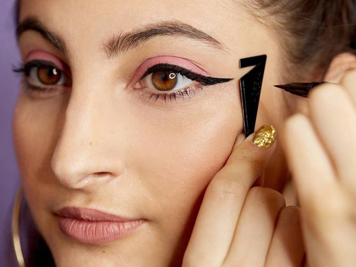 Close-up picture of a person applying liquid eyeliner