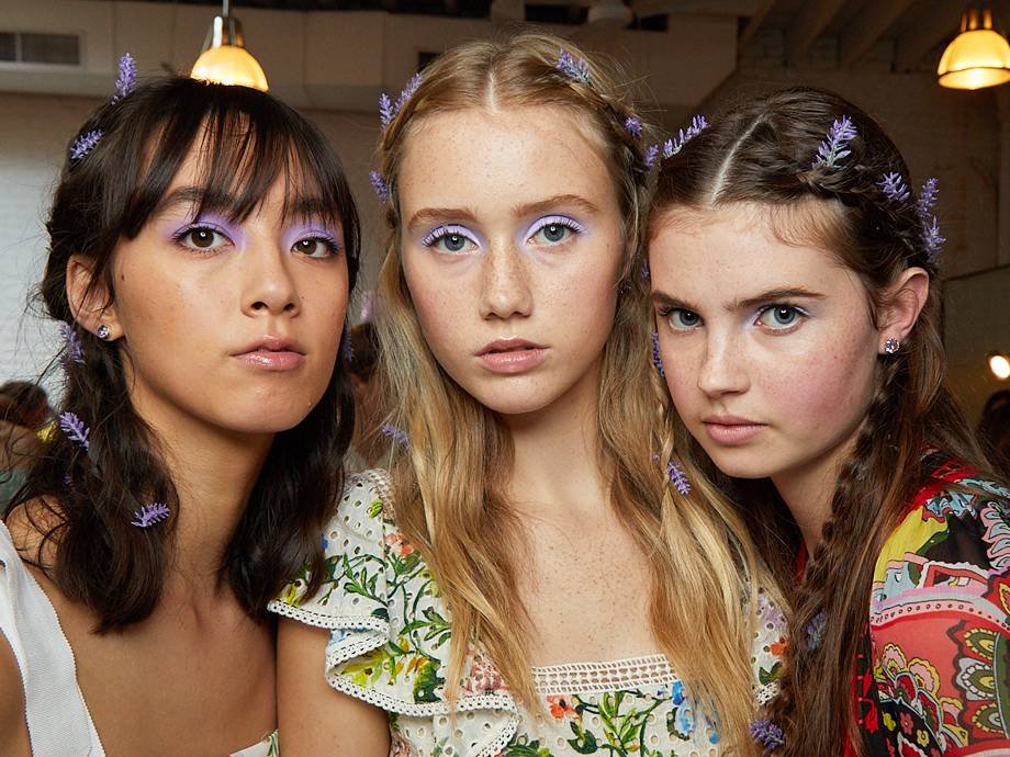 three people posing and wearing lavender eyeshadow