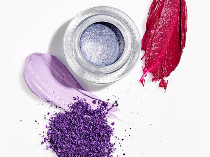 eyeshadow pot surrounded by makeup swatches