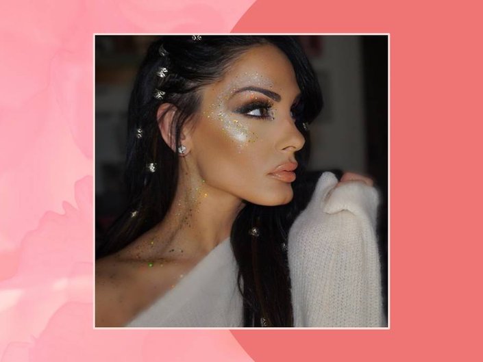 person wearing glitter makeup on face and neck