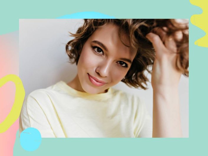 person with short hair in loose curls