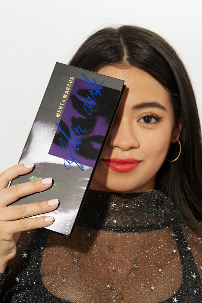 person holding eyeshadow palette up to face