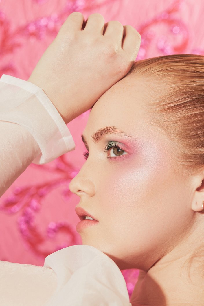 side profile of person wearing pink eye makeup and blush