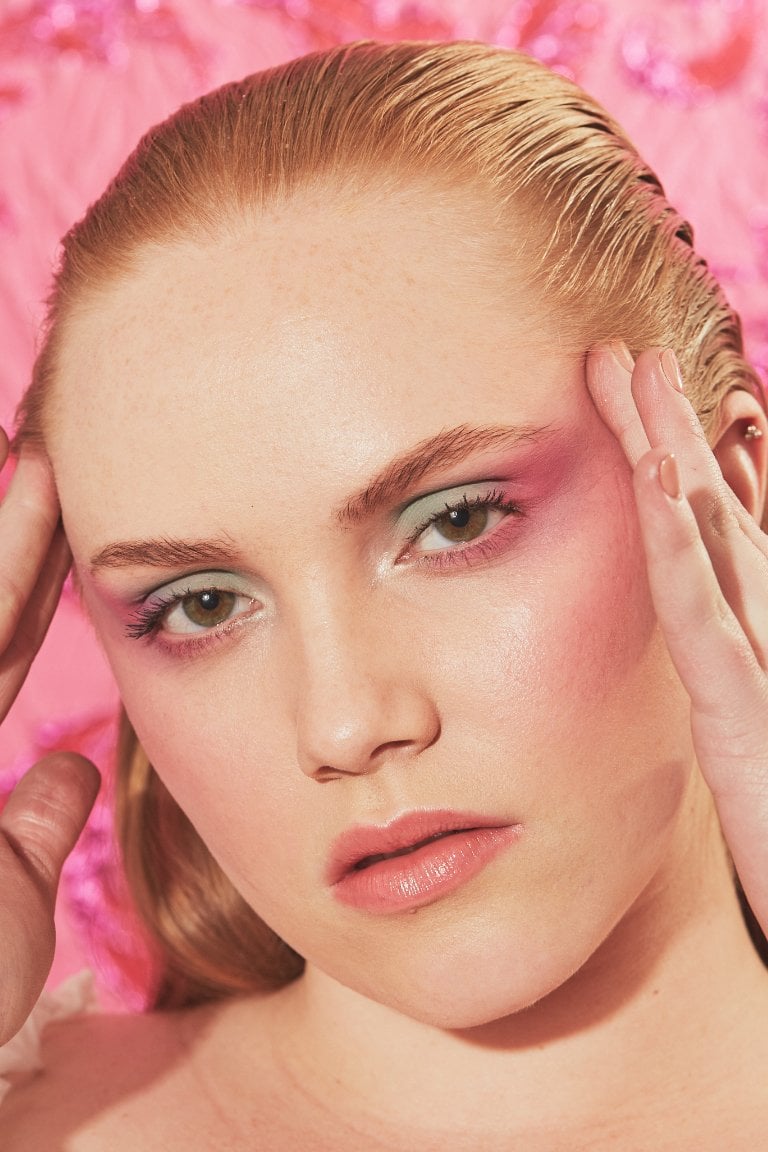person wearing pink eye makeup and blush