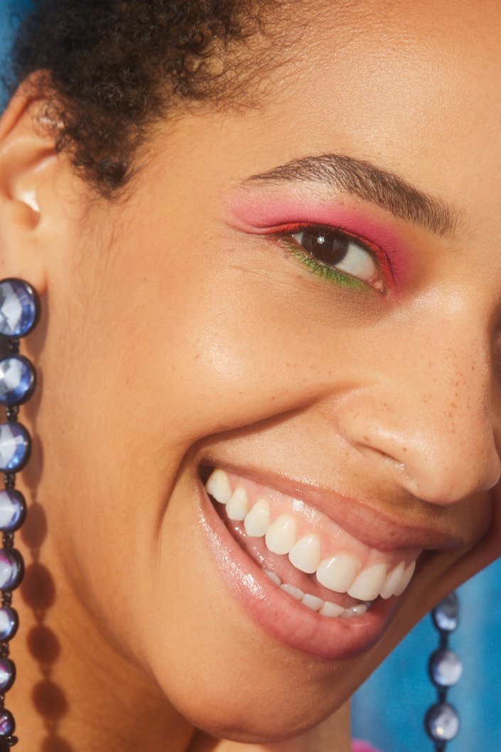 person wearing pink, coral and green eyeshadow