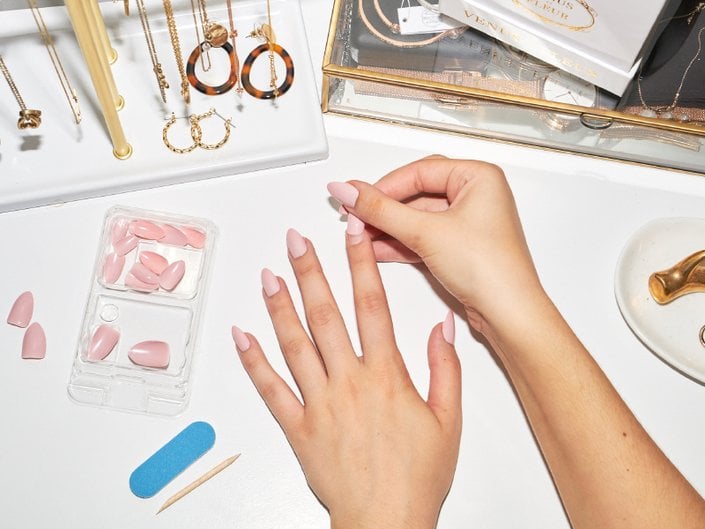hand applying press-on nail