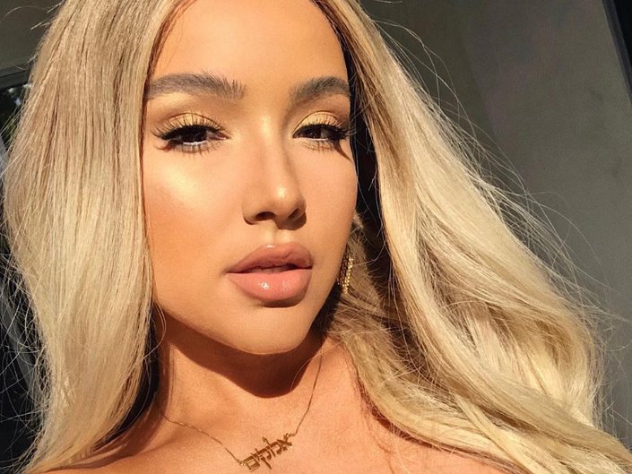person with blonde hair wearing dewy makeup