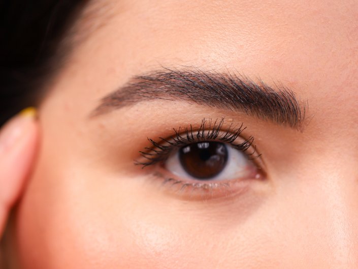 close-up of person's eye with long eyelashes