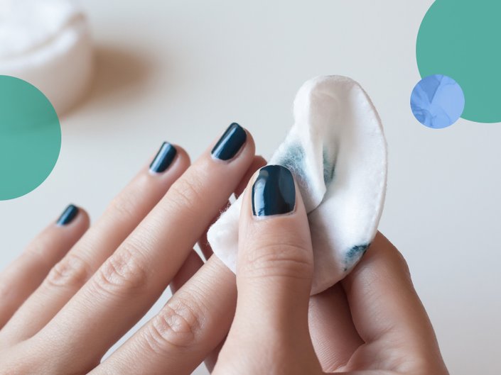 hand removing nail polish from nail with cotton pad