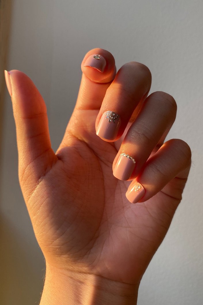 hand with bedazzled nails