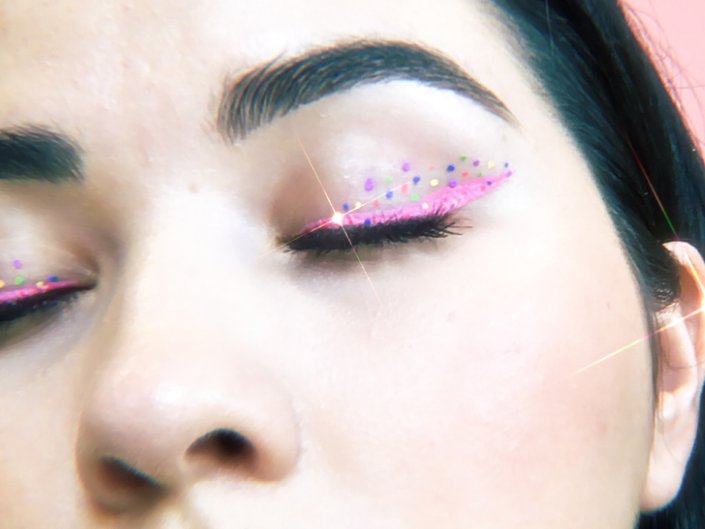 person wearing pink and multicolored dots eye makeup