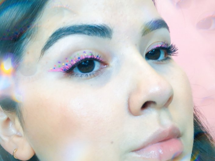 person wearing pink and multicolored dots eye makeup