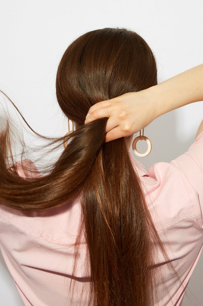 person braiding their hair