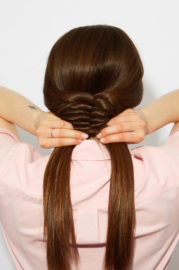 person braiding their hair