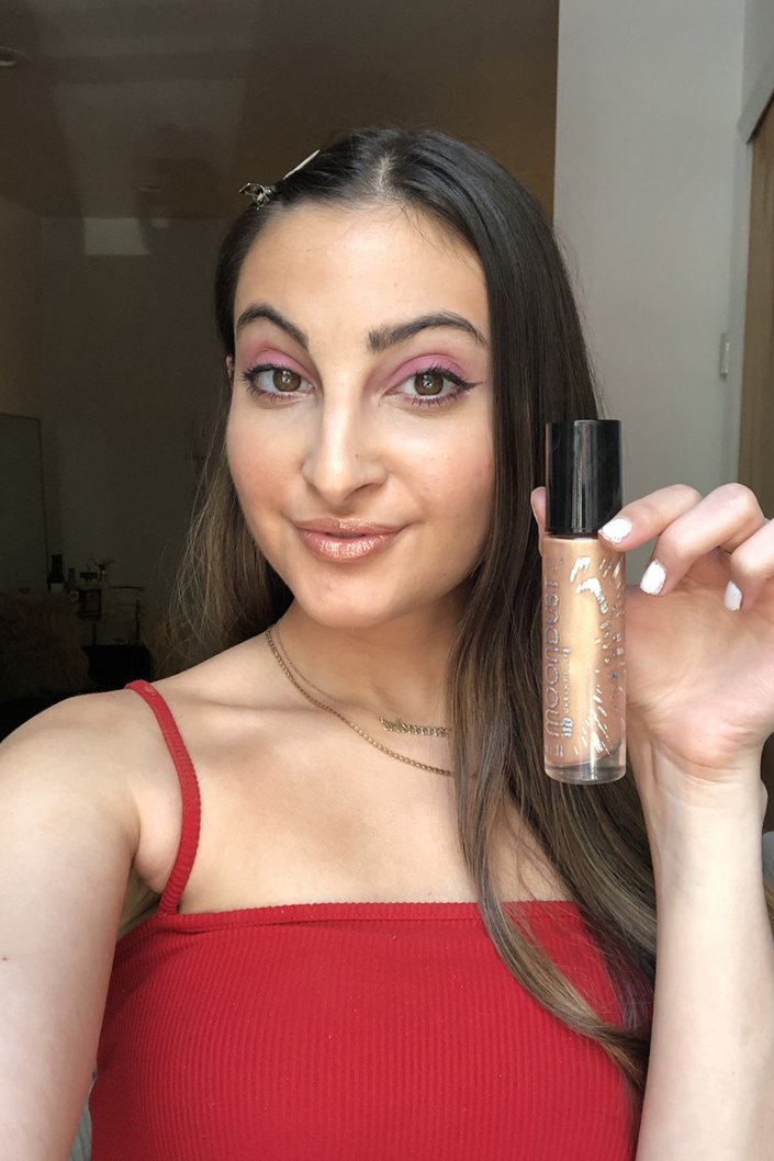 person posing with urban decay moondust glitter liquid