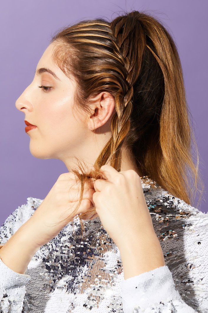 person braiding hair