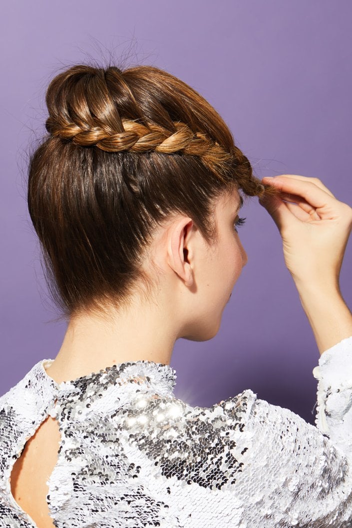 person wrapping braid around ponytail