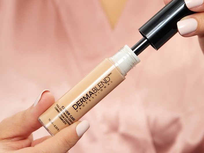 hands holding Dermablend Cover Care Full Coverage Concealer