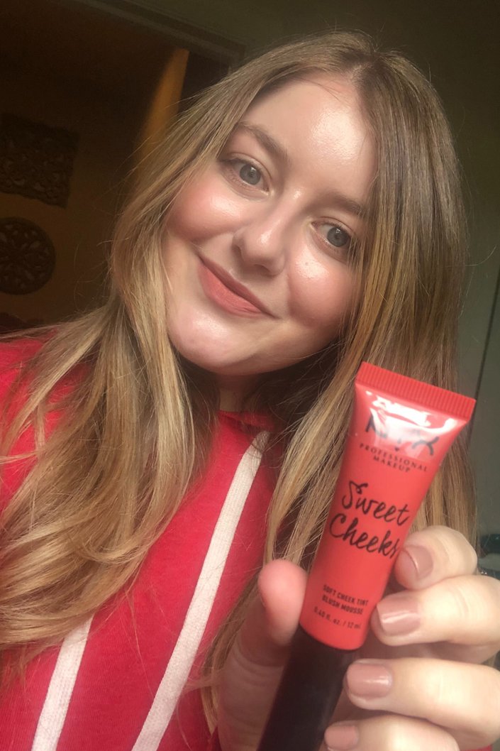 person wearing nyx professional makeup sweet cheeks lip and cheek tint in coralicious