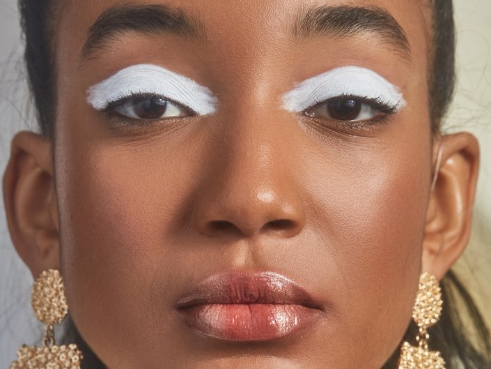person wearing white eyeshadow and lip art