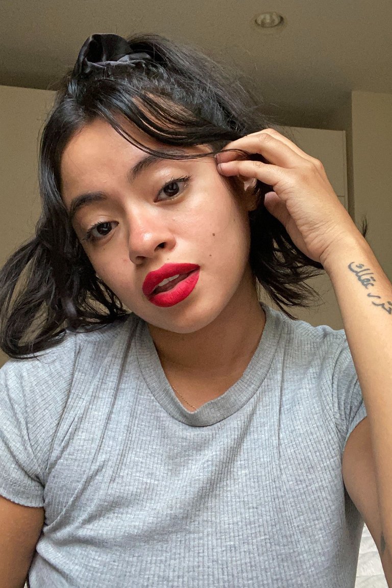 person posing and wearing red lipstick