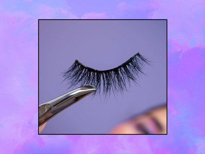 tweezer holding false eyelash strip