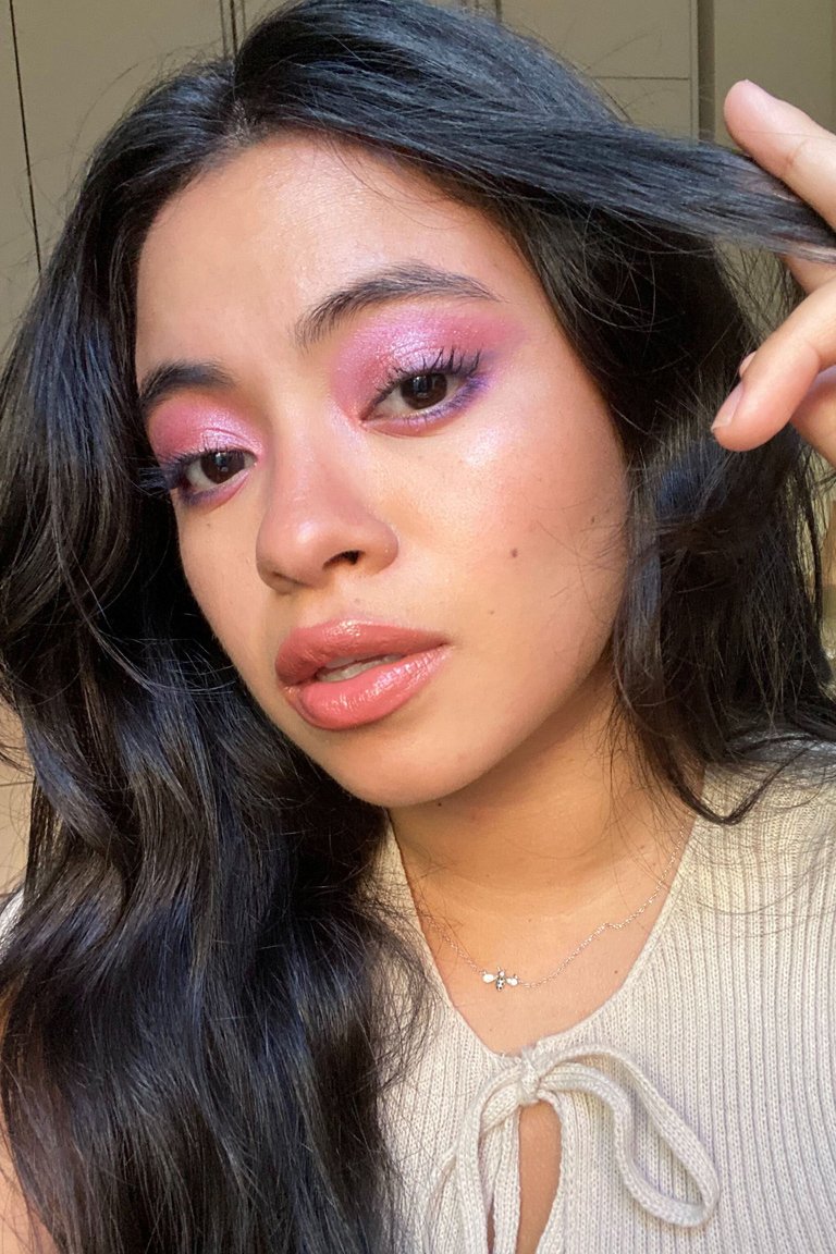 person wearing pink glitter and purple eyeshadow