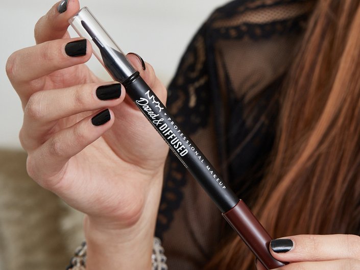 hands holding NYX Professional Makeup Dazed and Diffused Blurring Lipstick