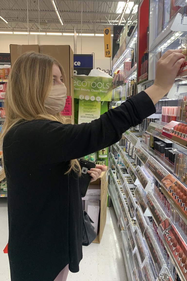 person in walmart next to lipstick display