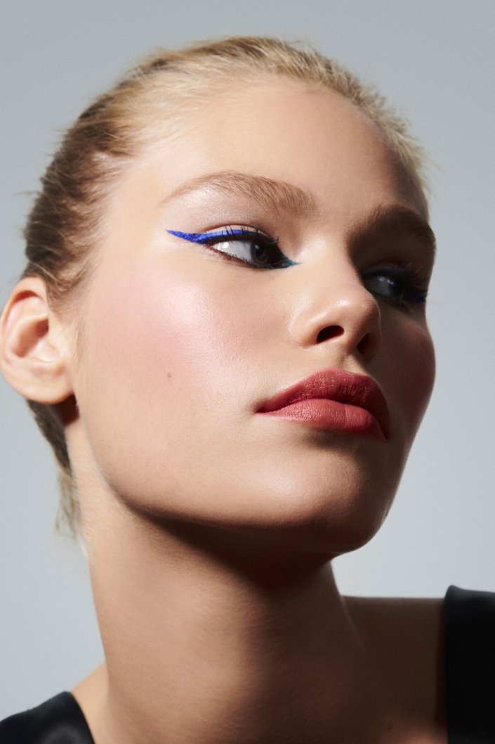 person wearing blue and green graphic eyeliner