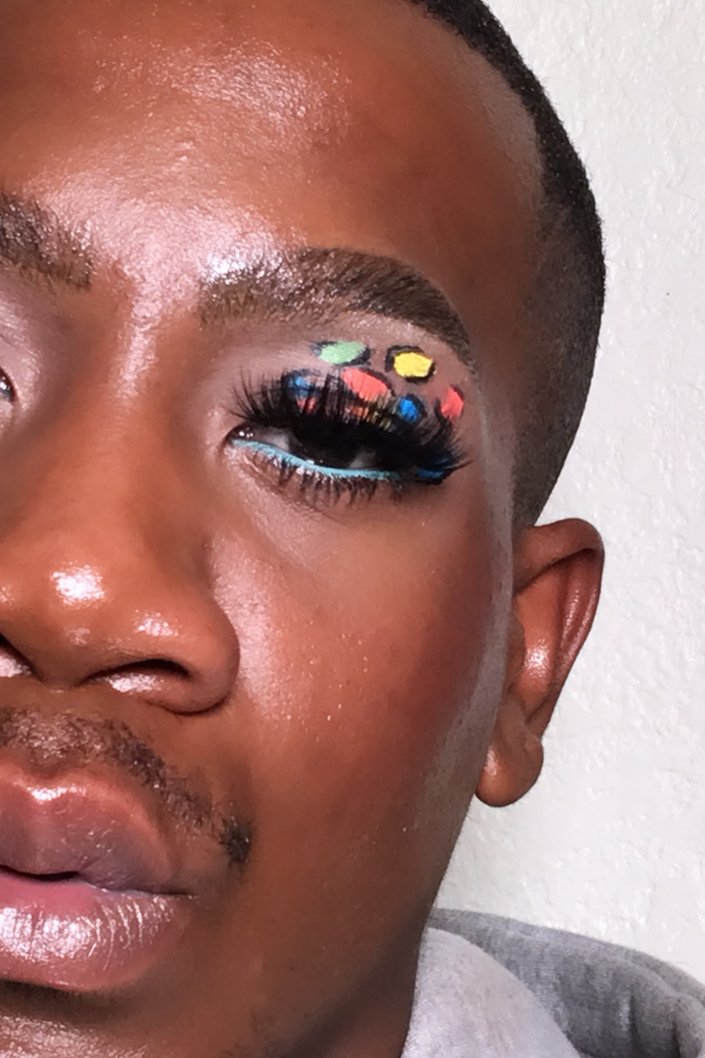 person wearing multicolored leopard-print eye makeup