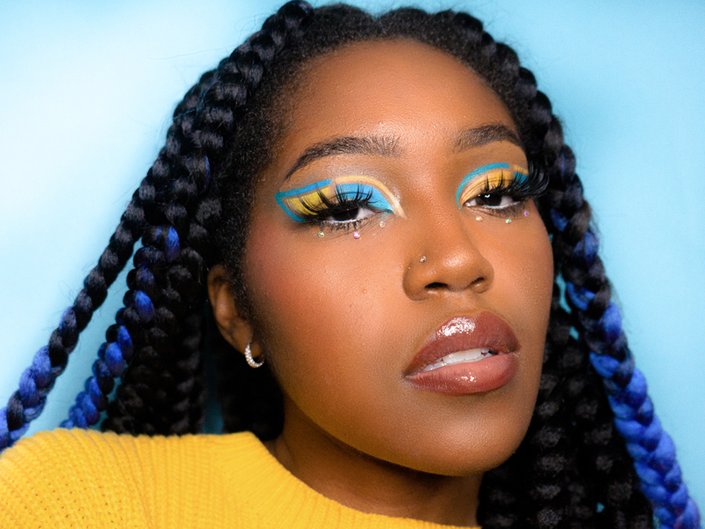 person wearing yellow and blue graphic eye makeup