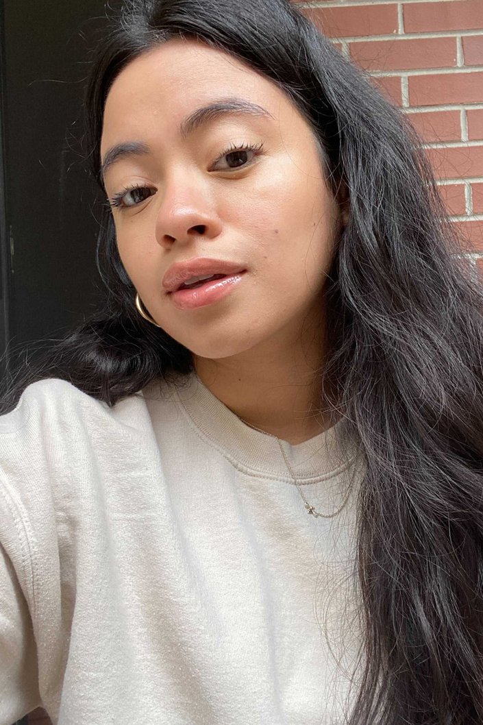 person wearing Tower28 ShineOn Milky Lip Jelly Gloss