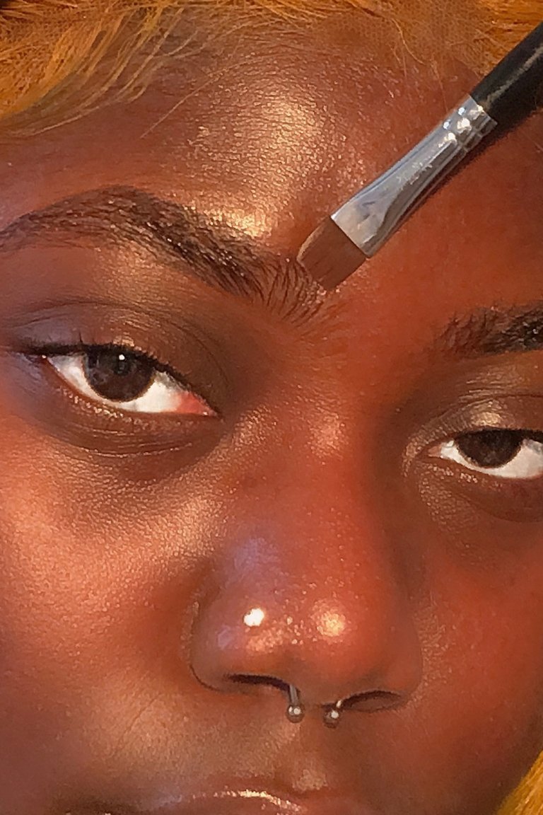 person applying makeup to face