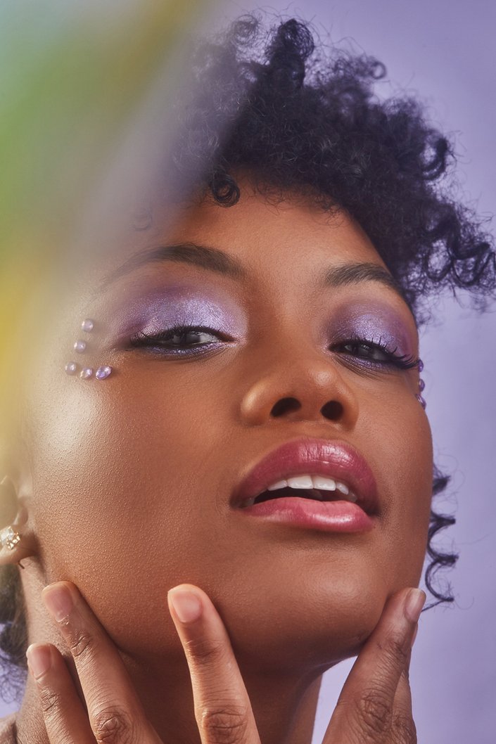 person wearing rhinestone eye makeup