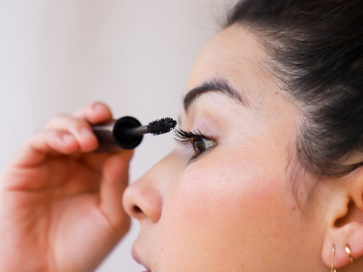 person applying mascara